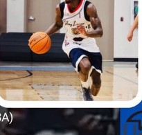 Basketball player driving to the rim under indigo court lights